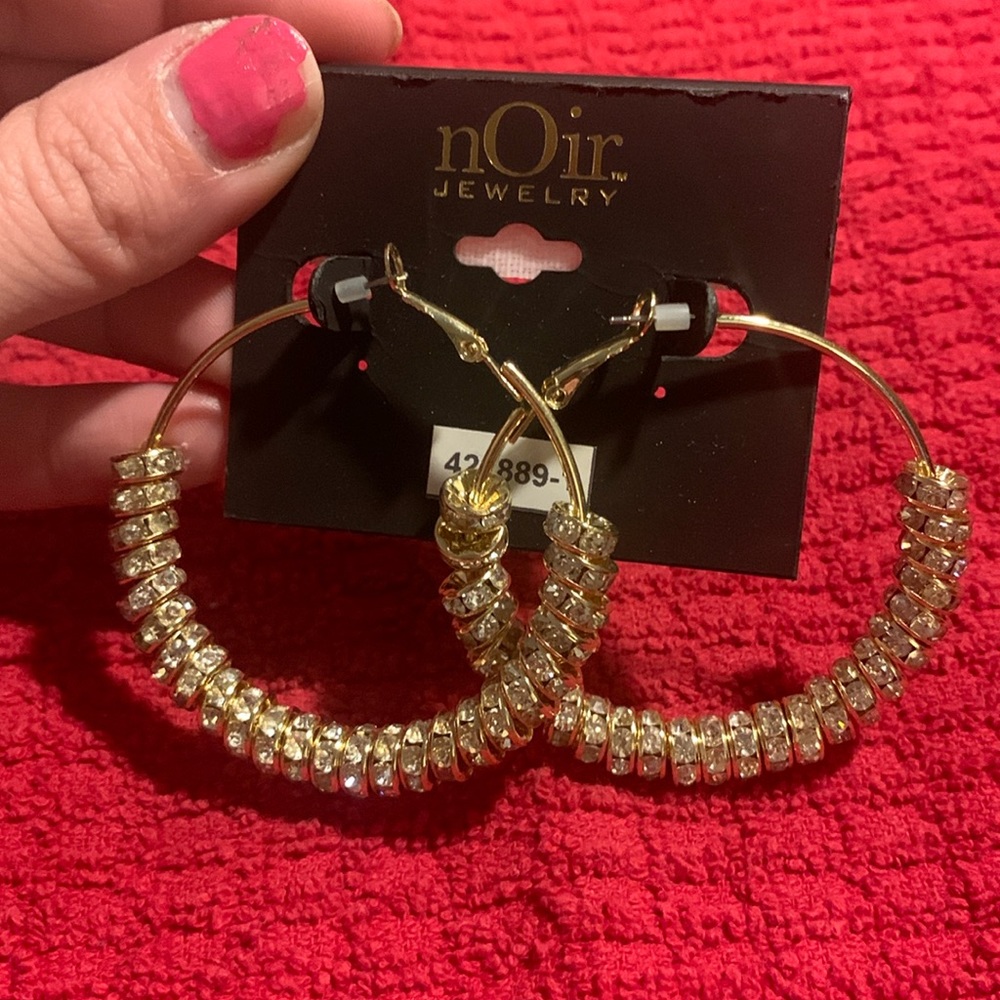 Noir jewelry gold hoop earrings with circles of gemstones.